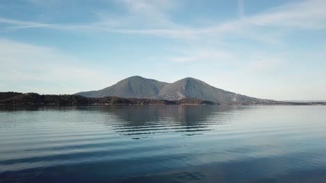 Low-Point-of-View-Aerial-flying-over-clear-lake-in-California