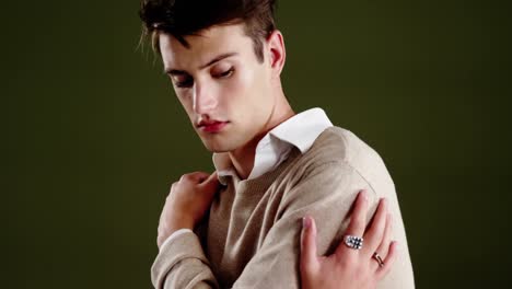 Androgynous-man-posing-against-black-background