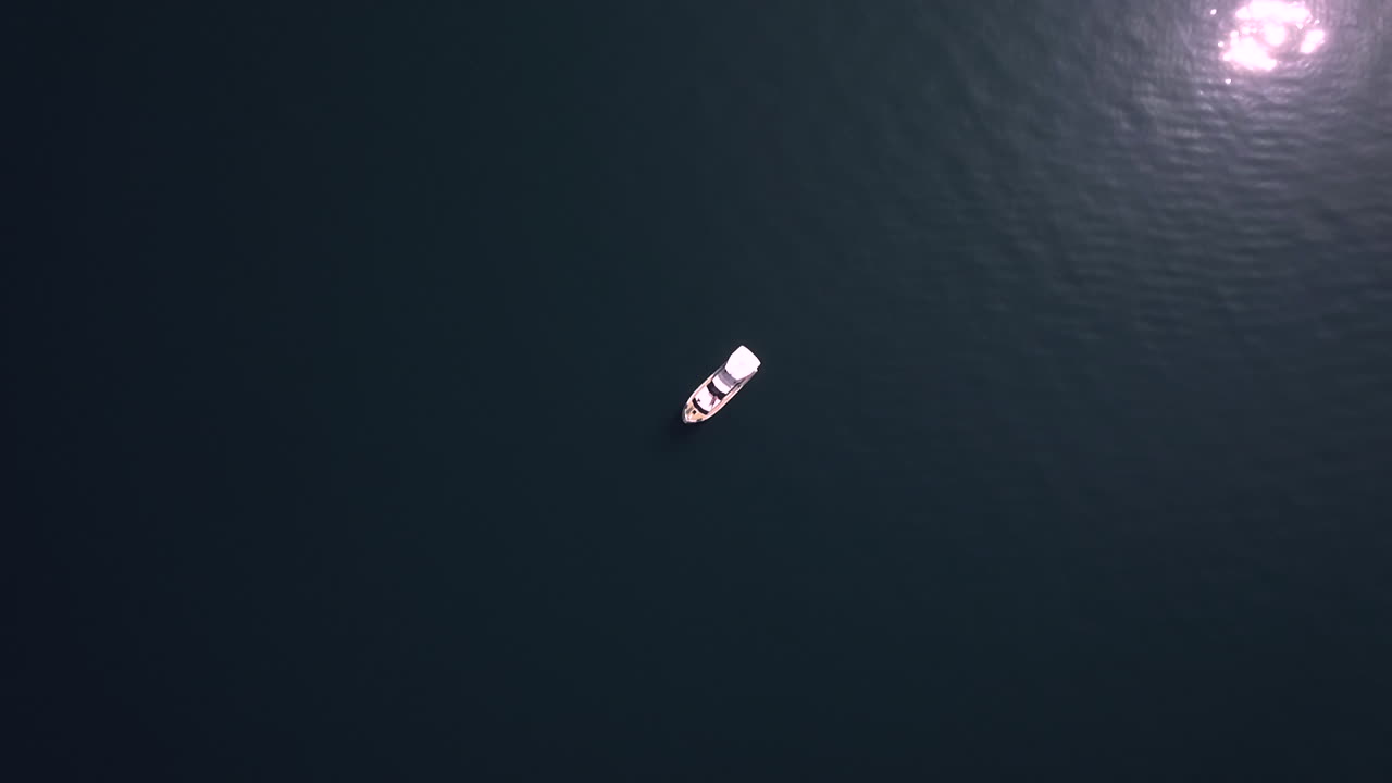 Yacht Boat alone reveal on Water with Aerial Drone top Down Shot