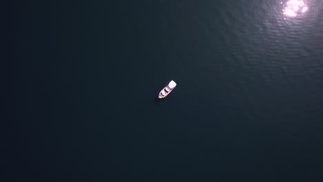 yacht boat alone reveal on water with aerial drone top down shot