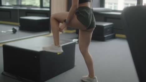 woman doing box jumps in gym