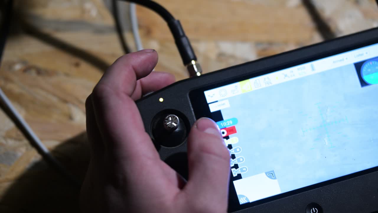 In the darkness of an underground bunker, a Ukrainian drone operator guides a military drone toward Russian positions on the frontline in Ukraine.