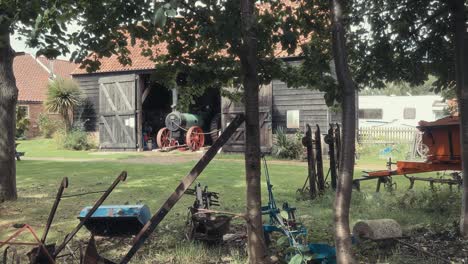 old vintage historical farm machinery equipment sitting around in a farmers field