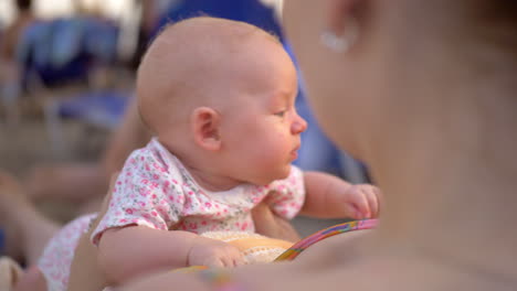 mother with baby daughter relaxing at the beach