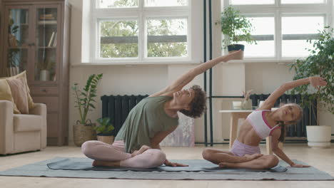 mother and daughter doing yoga at home