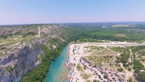 aerial view of people relaxing by a river in a canyon