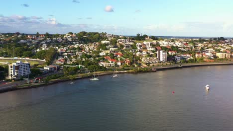 cinematic aerial view drone fly towards hamilton suburb capturing affluent riverside residential neighborhoods and hiiside homes in daytime, brisbane city, queensland, australia