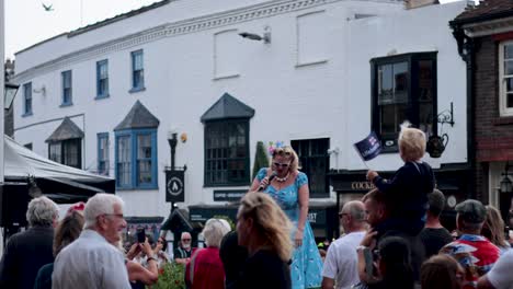 female singer entertains a lively street crowd