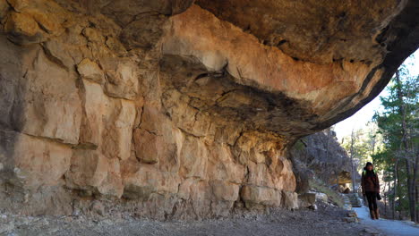 female hiker exploring cliff dwellings at walnut canyon