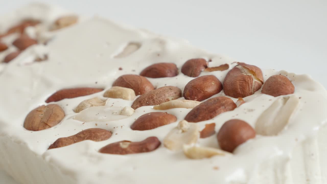 un primer plano cortando el nuez halva con un cuchillo video 4k