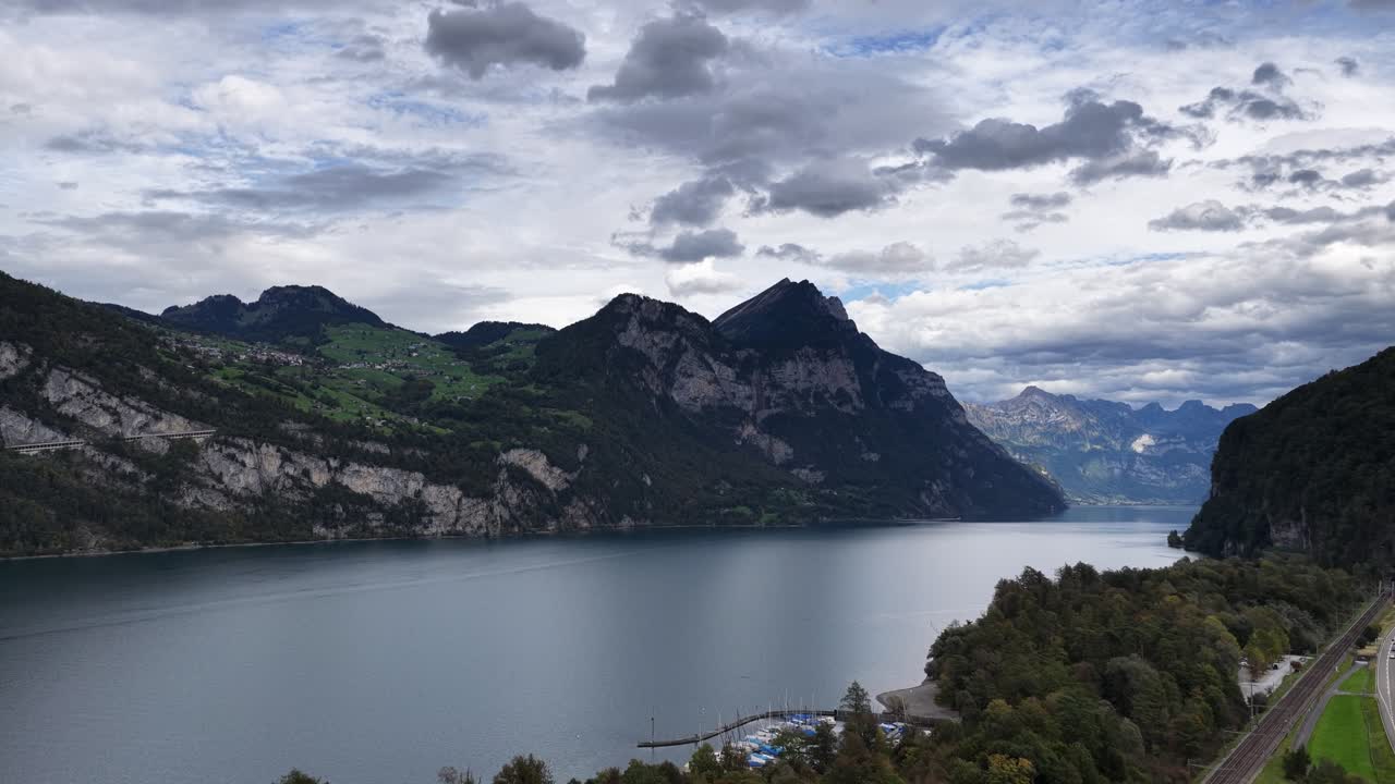Walensee lake surrounded by mountains and scenic road in Walenstadt Switzerland - Aerial