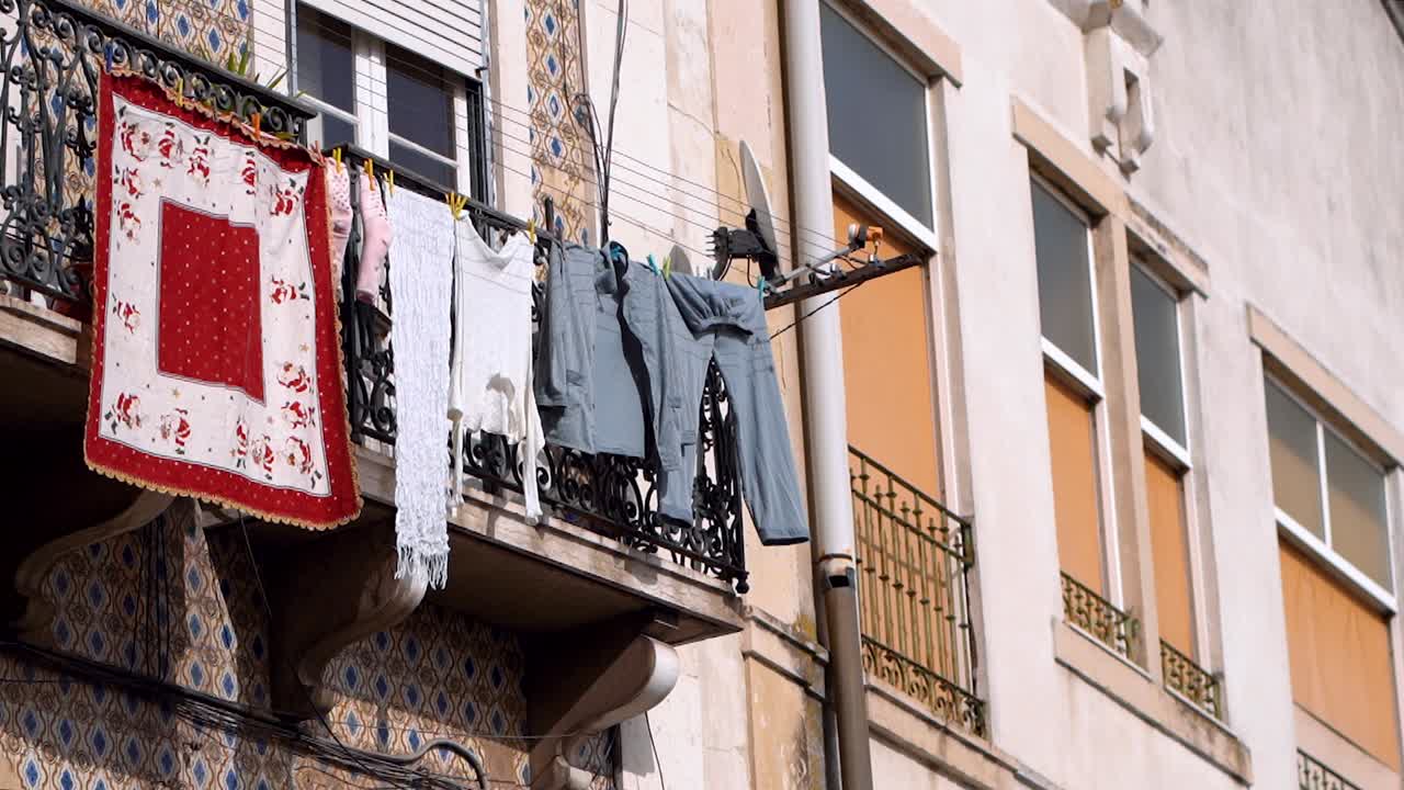 clothes hanging on clotheslines outside the balcony at residential building, City