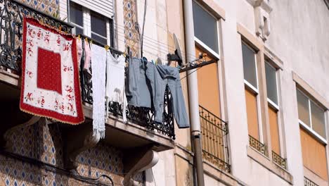 clothes hanging on clotheslines outside the balcony at residential building, city