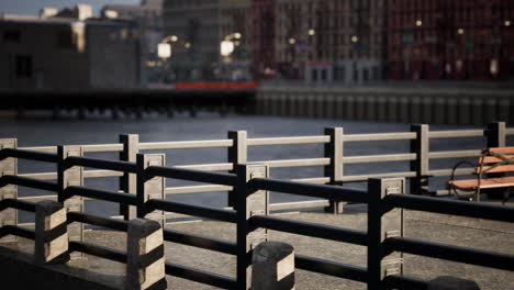 a bench on a riverbank in the city