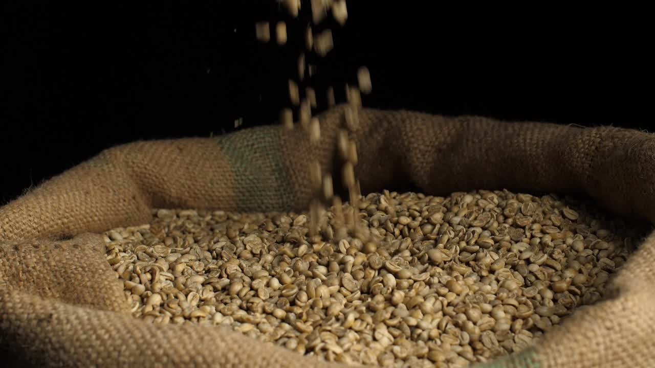 Freshly Green Coffee Beans Falling On Pile Of Seed In Sack Bag, Slow Motion