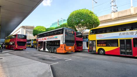 multiple buses parked at a busy station