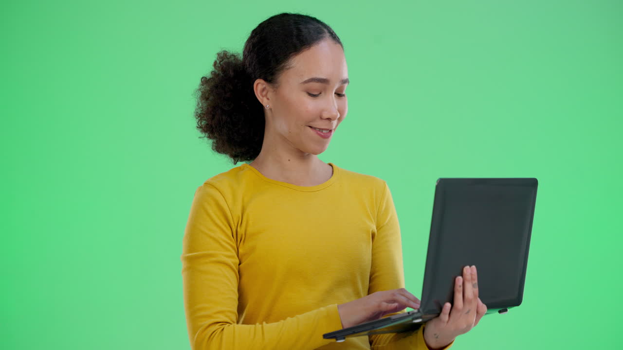 Woman Using Laptop on Green Screen