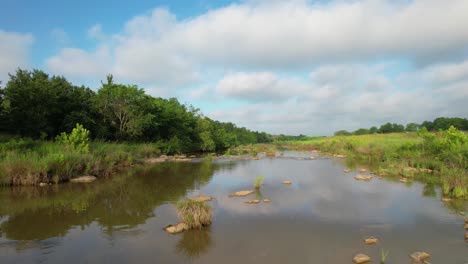 aerial footage flying low over the pedernales river near stonewall texas