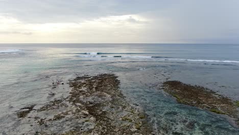 rocky shore with endless horizon in bali indonesia