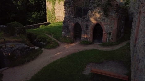 aerial view of castle ruins in a forest