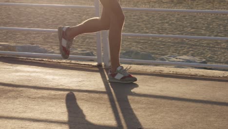person running on a beachfront path