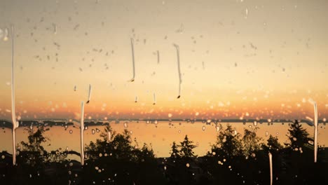 beautiful sunset and raindrops hitting a window