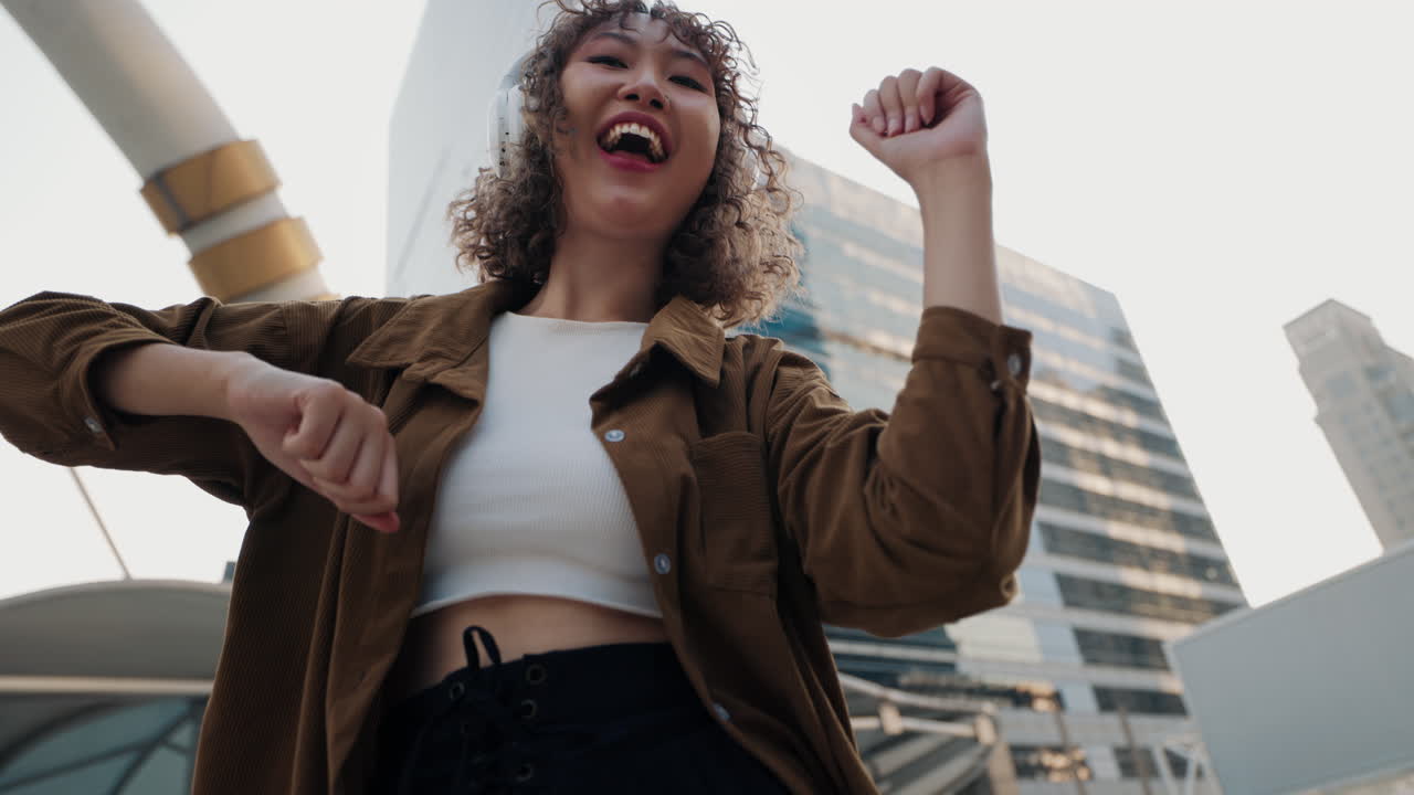 Woman Dancing in the City with Headphones