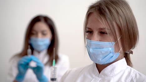 Retrato-De-Enfermera-Y-Doctora-Sosteniendo-Jeringa-Con-Vacuna-Para-Covid-19