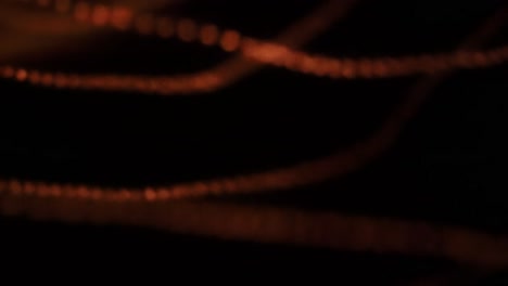 discover mesmerizing golden light trails swirling gracefully in a dimly lit environment. this enchanting display immerses viewers in an atmosphere of warmth and creativity.
