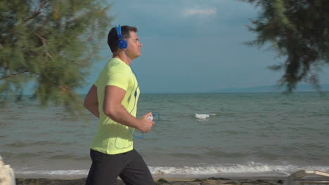 jogging with music and smartphone at the seaside