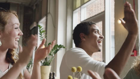 Young-man-celebrating-success-with-friends