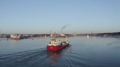 aerial shot of a small fishing boat by the harbor close to gothenburg, sweden