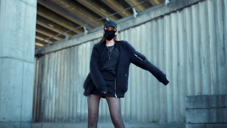 woman dancing on urban street. stylish girl making modern moves during dance