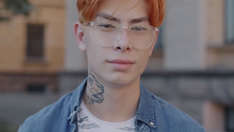young man with red hair and glasses