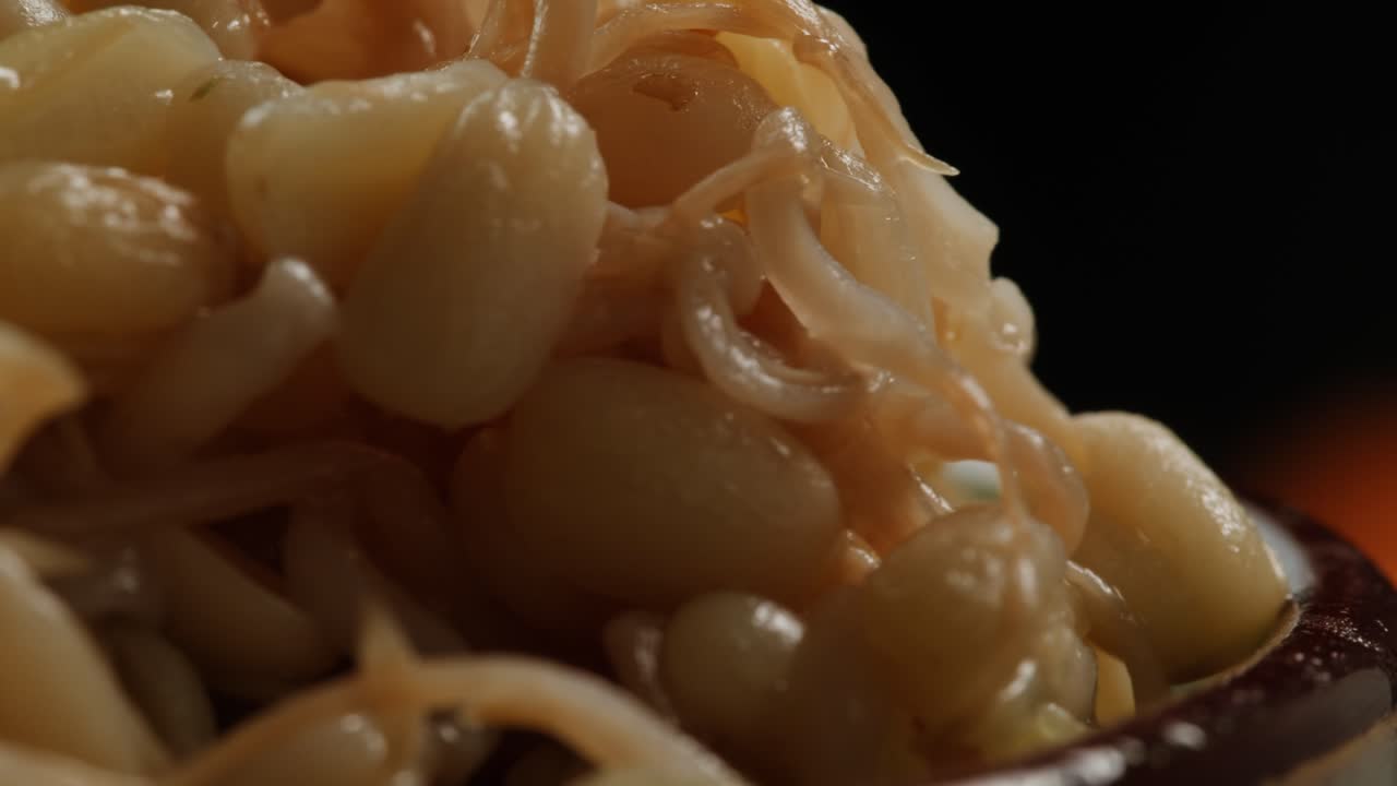 Salted soybean fermented in jar, chinese soy production, marinated food, germinated soy close up in cafe restaurant.