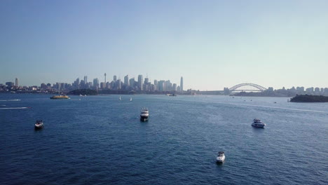 yachts and boats floating in sydney harbour with sydney cbd and sydney harbour bridge in background in nsw, australia