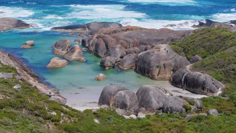 cinematic flight around elephant rocks with people standing in the distance