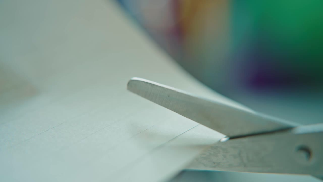 Close-up of scissors cutting paper in a creative and focused activity