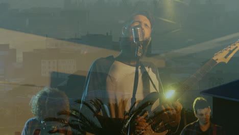 rock band members performing on green-tinted stage, projecting animated city skyline and palm trees