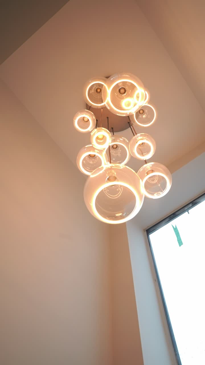 Modern ceiling light creates warm atmosphere with unique glass design