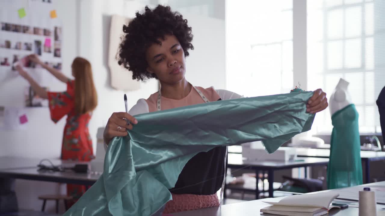 Mixed race woman working in fashion office
