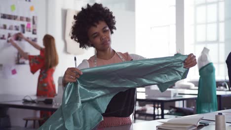 mixed race woman working in fashion office