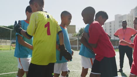 soccer kids shaking hands in a sunny day