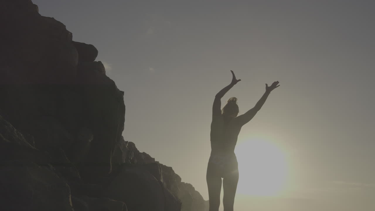 Woman on Rocks at Sunrise/Sunset