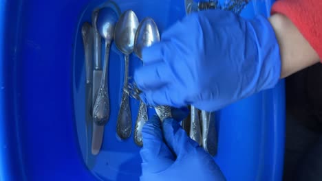 cleaning antique silverware with gloves