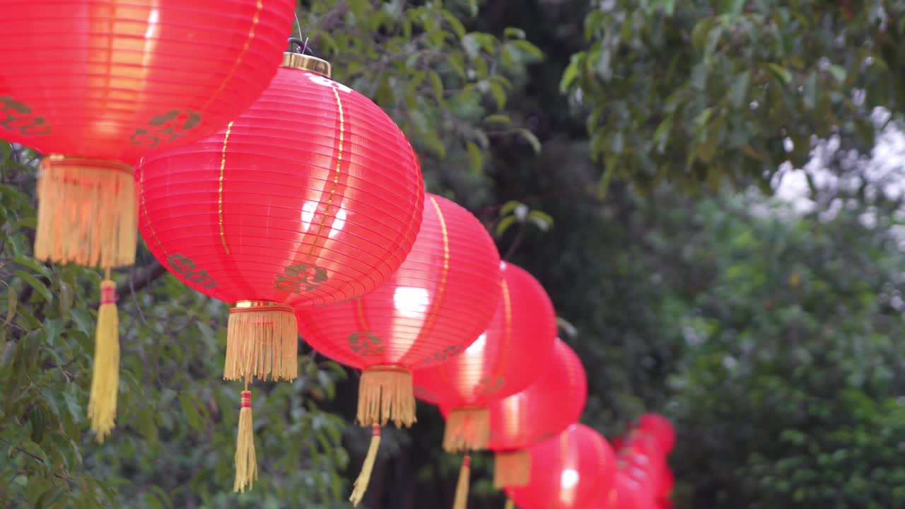 Red Chinese Lanterns Hanging Outdoors in a Row