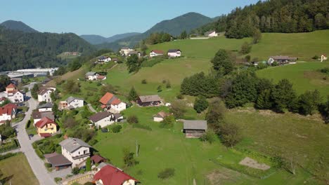 Top,-drone-view-of-small-town,-human-settlement,-surrounded-by-forests
