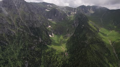 lush green malaiesti valley in the bucegi mountains with cloudy skies, aerial view