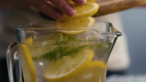 close up of woman making lemonade in the kitchen.