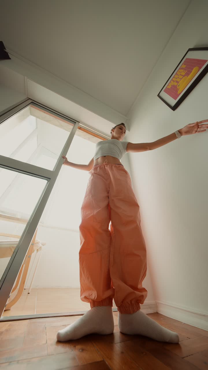 A woman in casual wear standing indoors